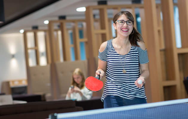 Student playing table tennis in halls