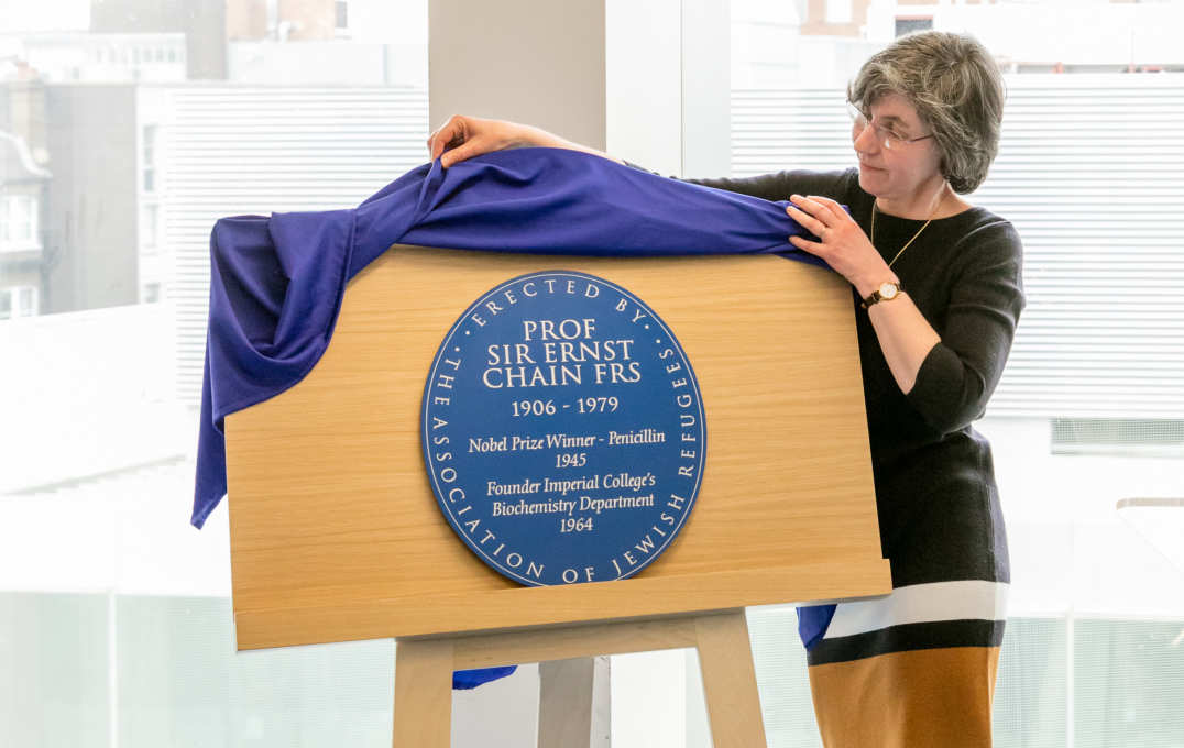 Woman unveiling a plaque on an easel