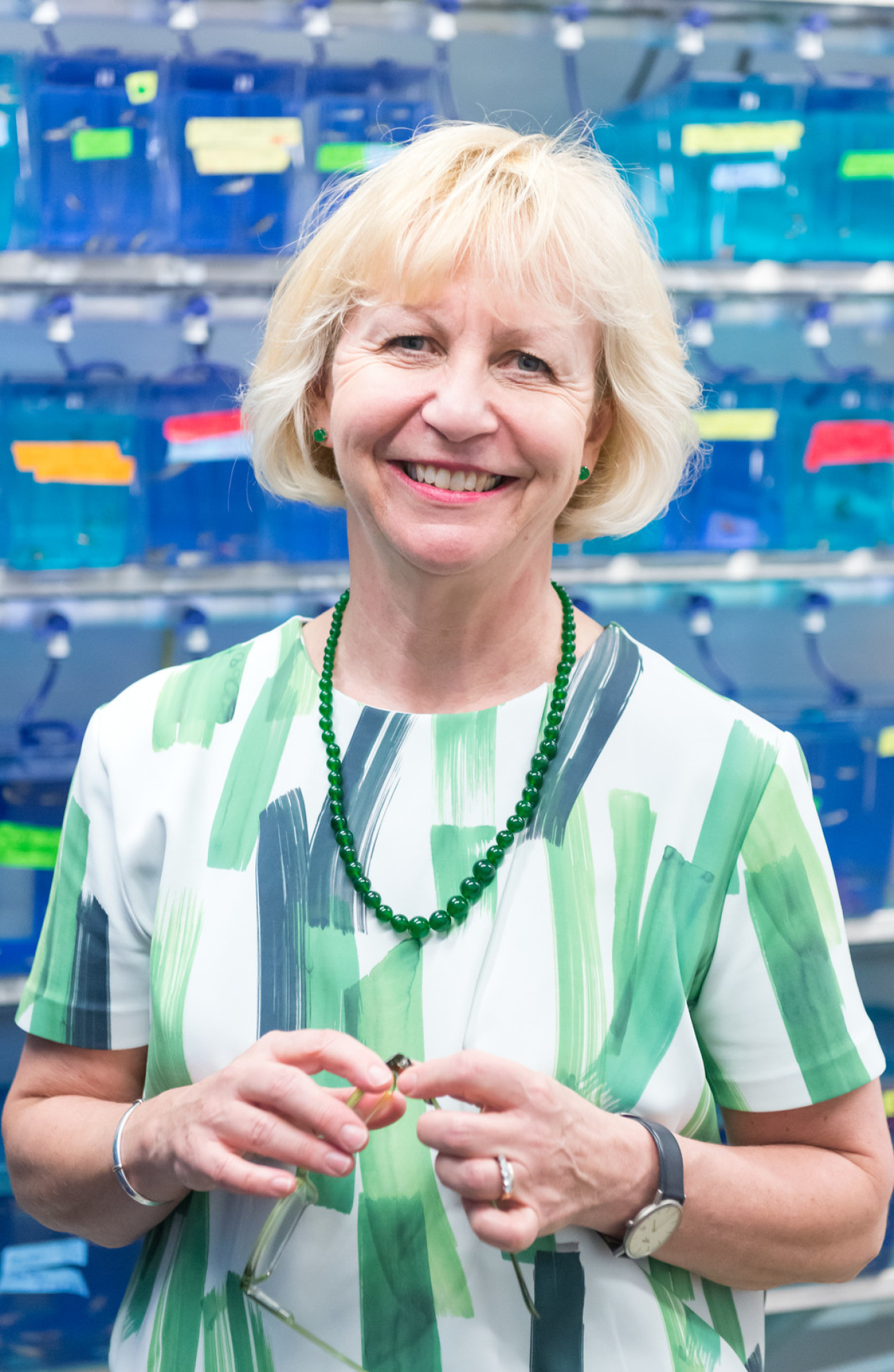 Smiling woman wearing green and white patterned top