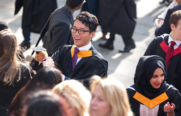3 students eagerly await the presentation of their certificates at their graduation ceremony at the Royal Albert Hall