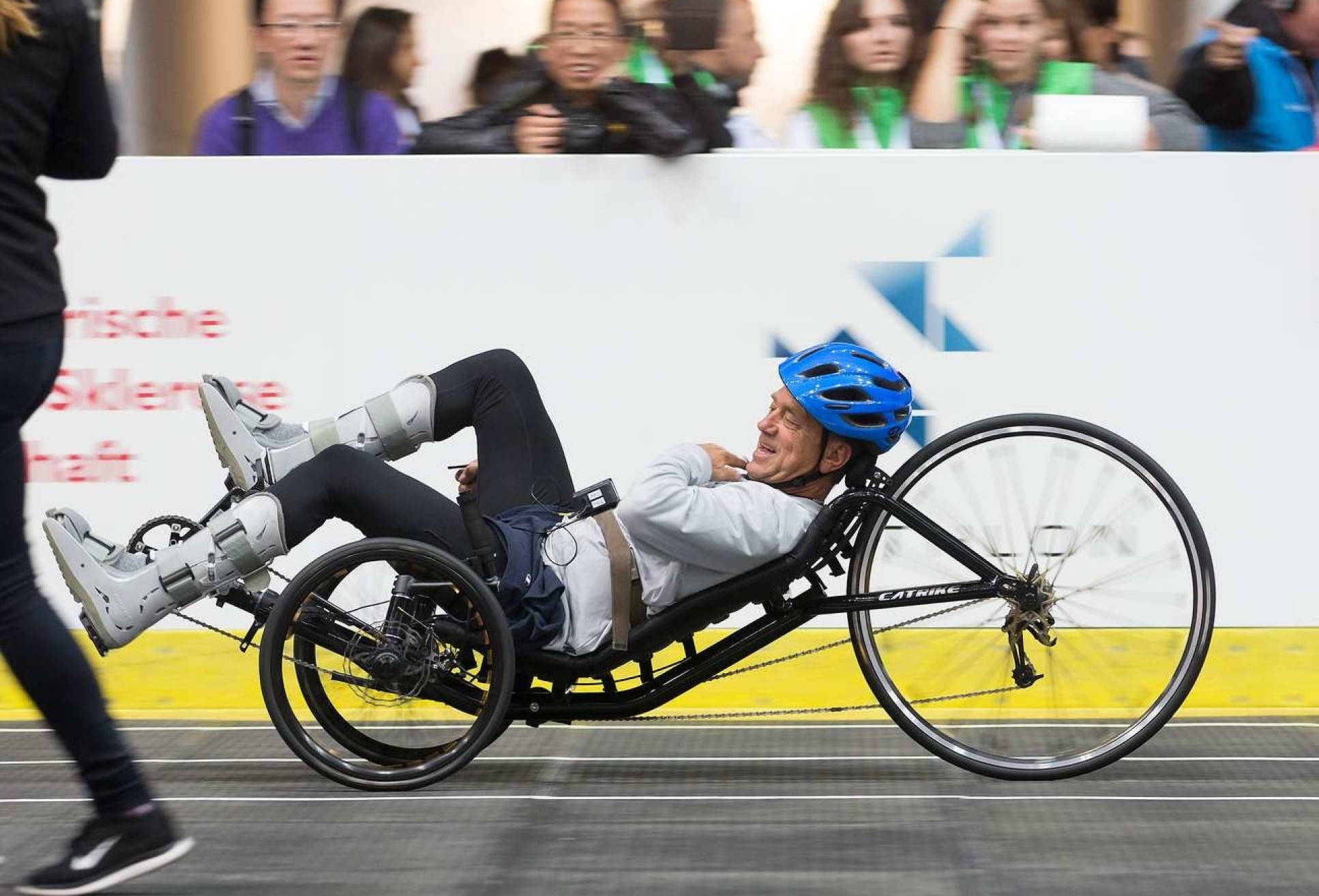 Photo of a man leaned back into a FES bike during a Cybathlon race