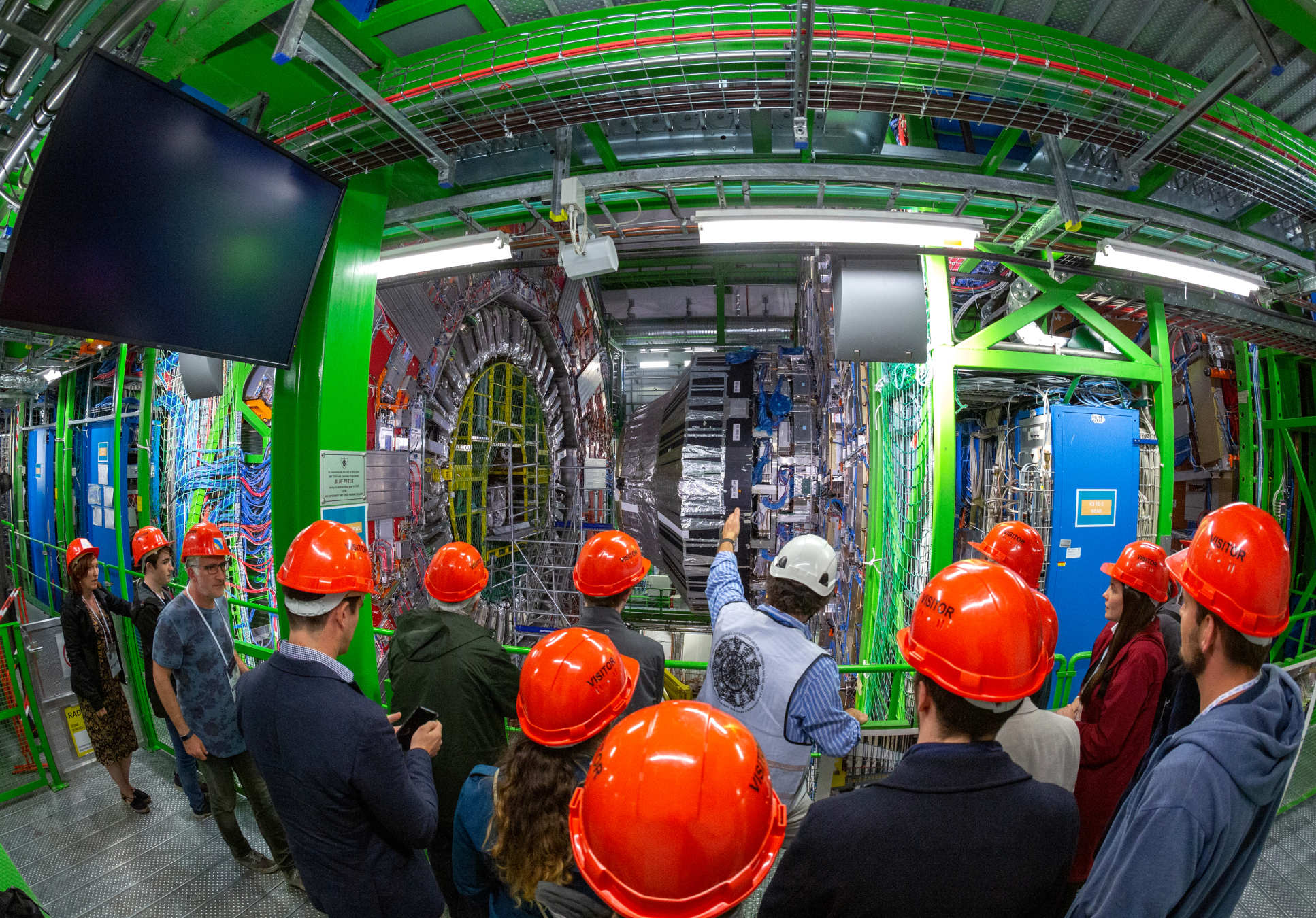Alumni looking at the Large Hadron Collider