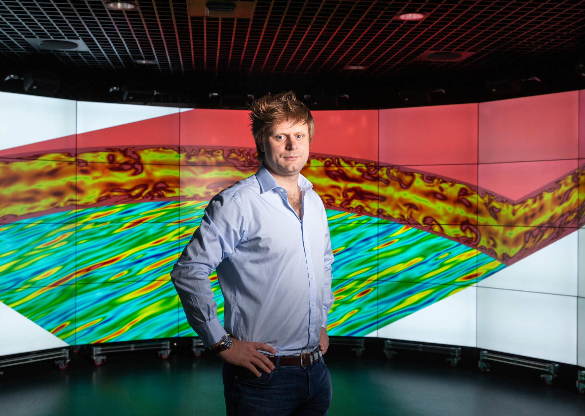 Dr Peter Vincent in front of a screen showing one of the flow simulations