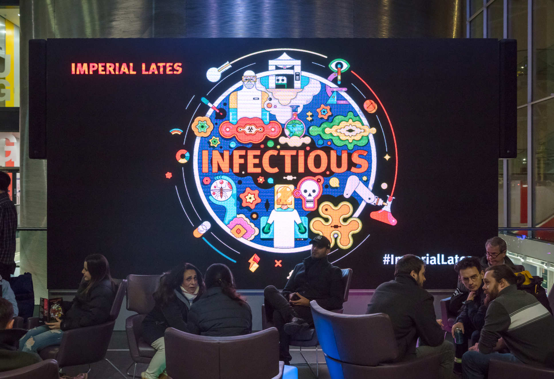 The Imperial Lates: Infectious logo on a big screen in the College's main entrance