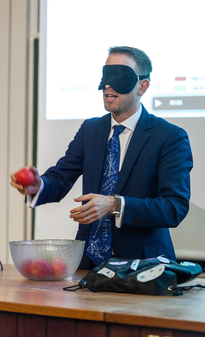 Roberto Trotta at his inaugral lecture. He holds apples while blindfolded