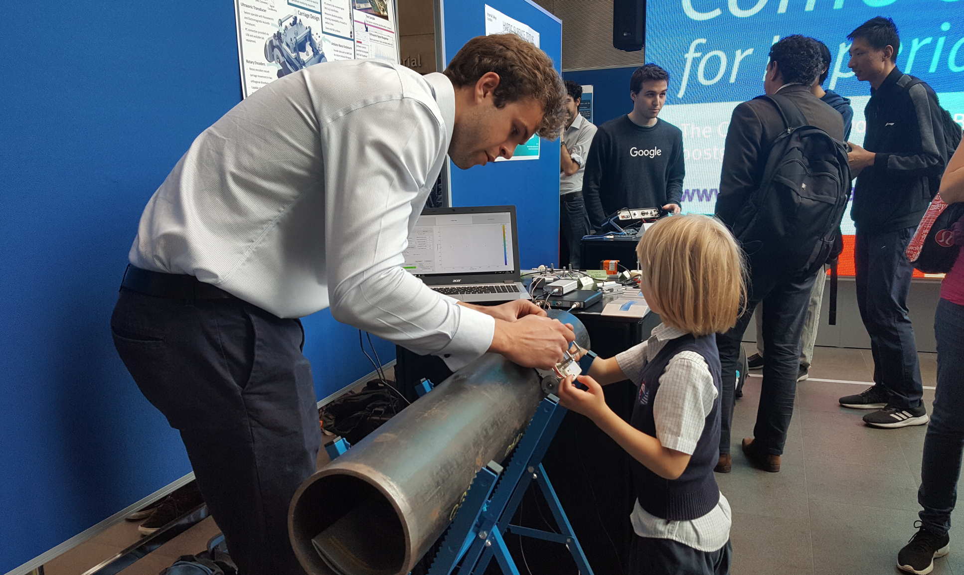 Inspiring the younger generations: student Ben Hambrook explains his project on ultrasonics to a five year old visitor 