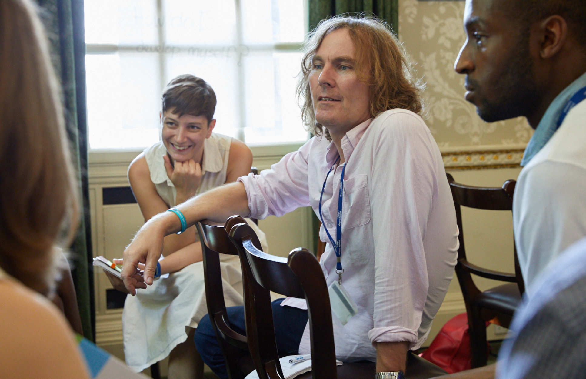 people sitting informally on chairs discussing