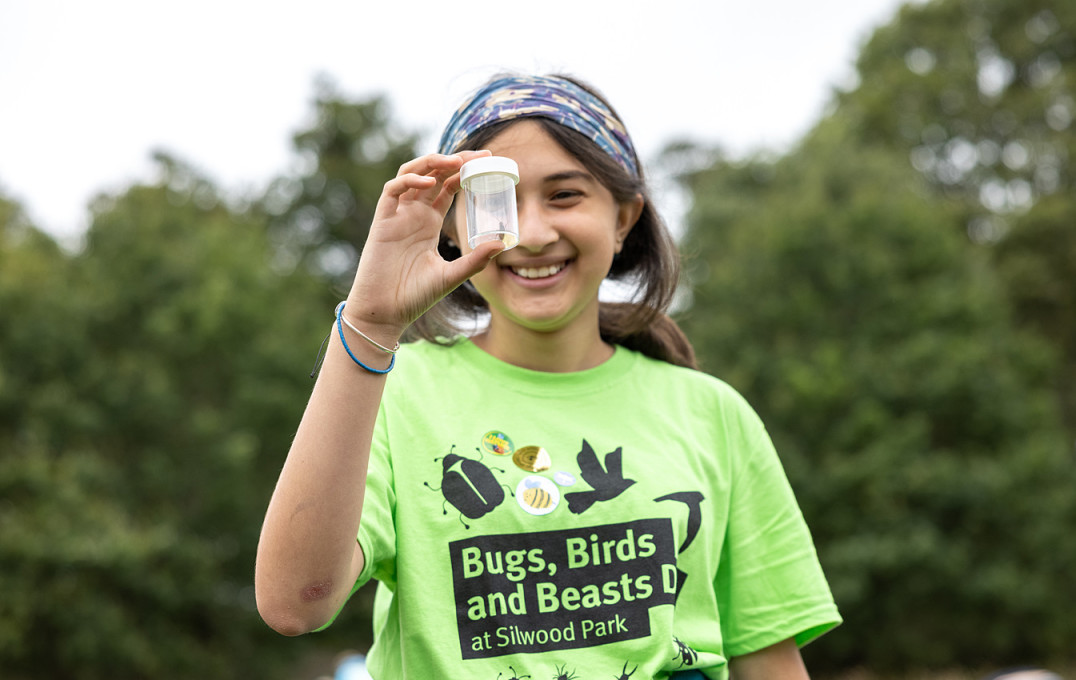 Girl holding an insect in a tube