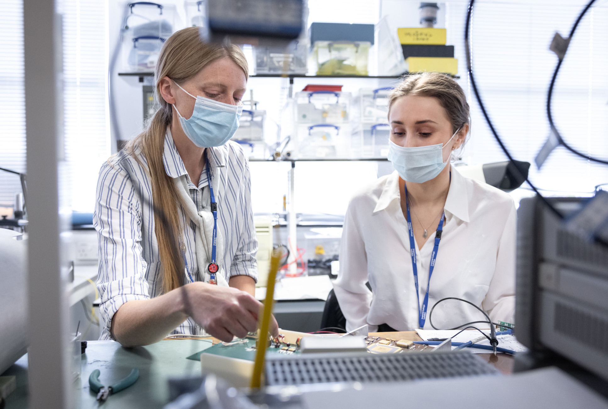 two women looking at scientific equipment