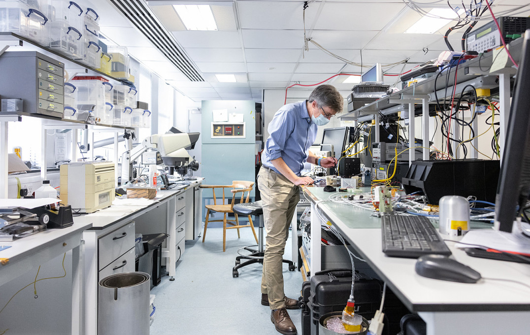 Man working on electronics at a lab bench