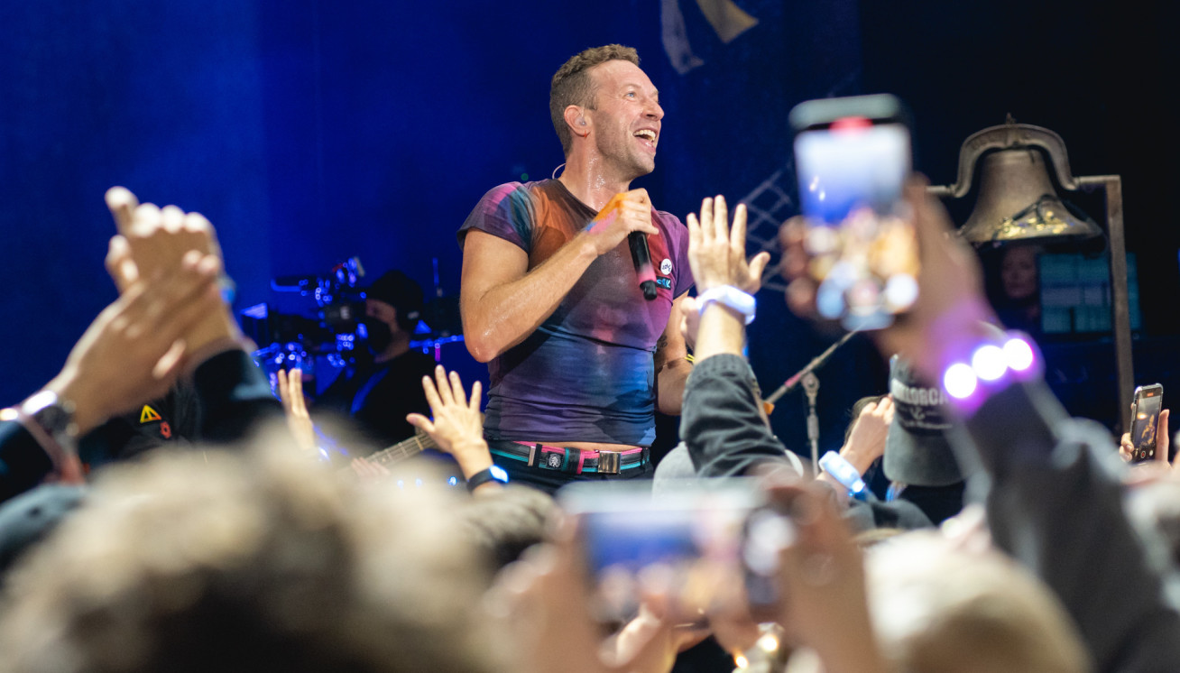 Photo of Chris Martin, lead singer of coldplay, performing at a concert