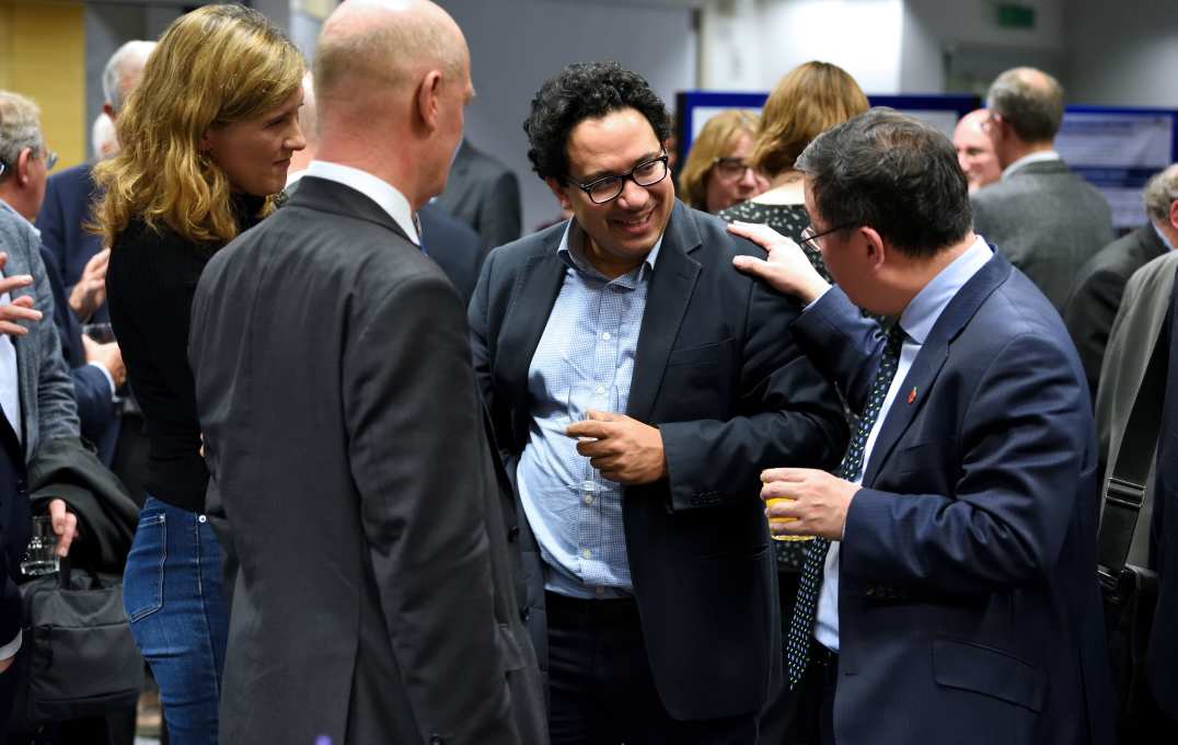 Professor Yike Guo (R), Lord David Willetts (second L), and guests chatting and smiling