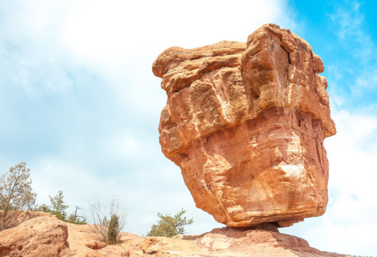 Photo of a large boulder balanced precariously on top of a another