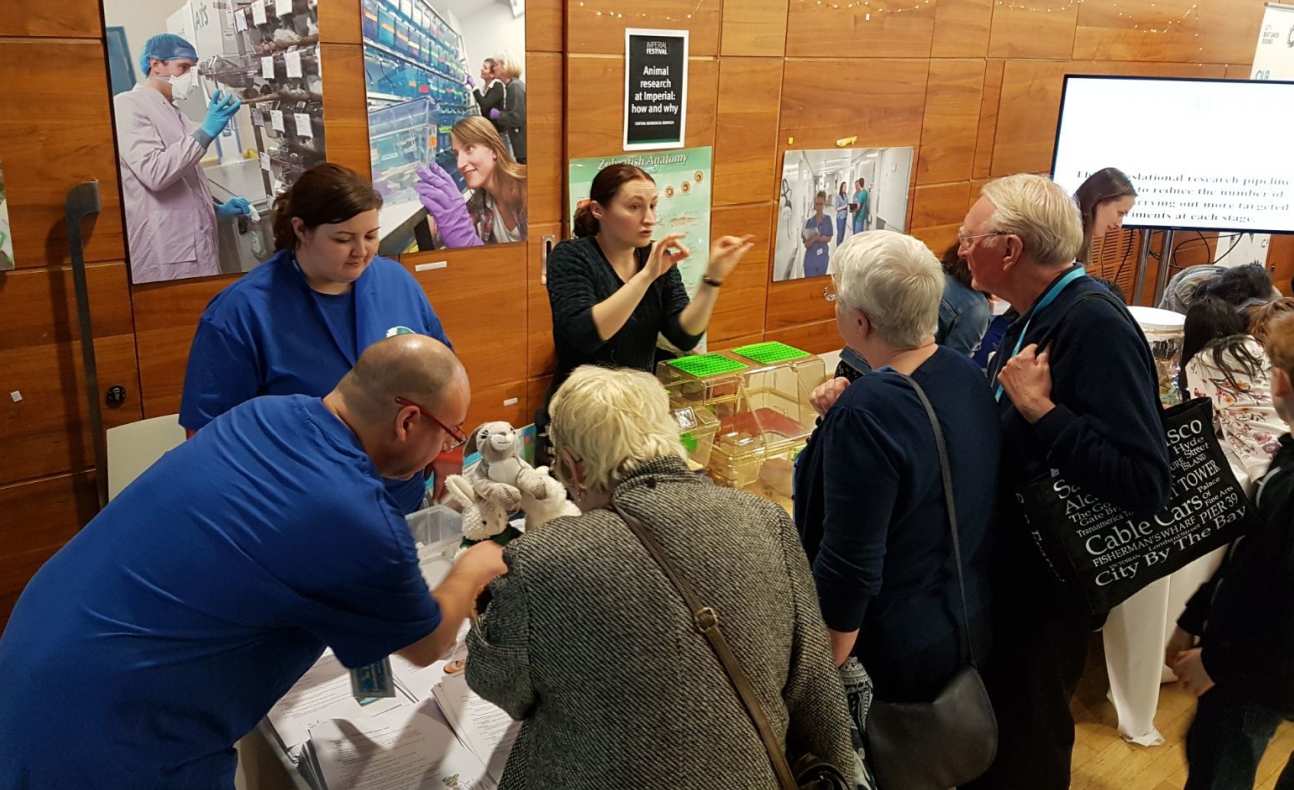 Visitors gather round the animal research exhibit