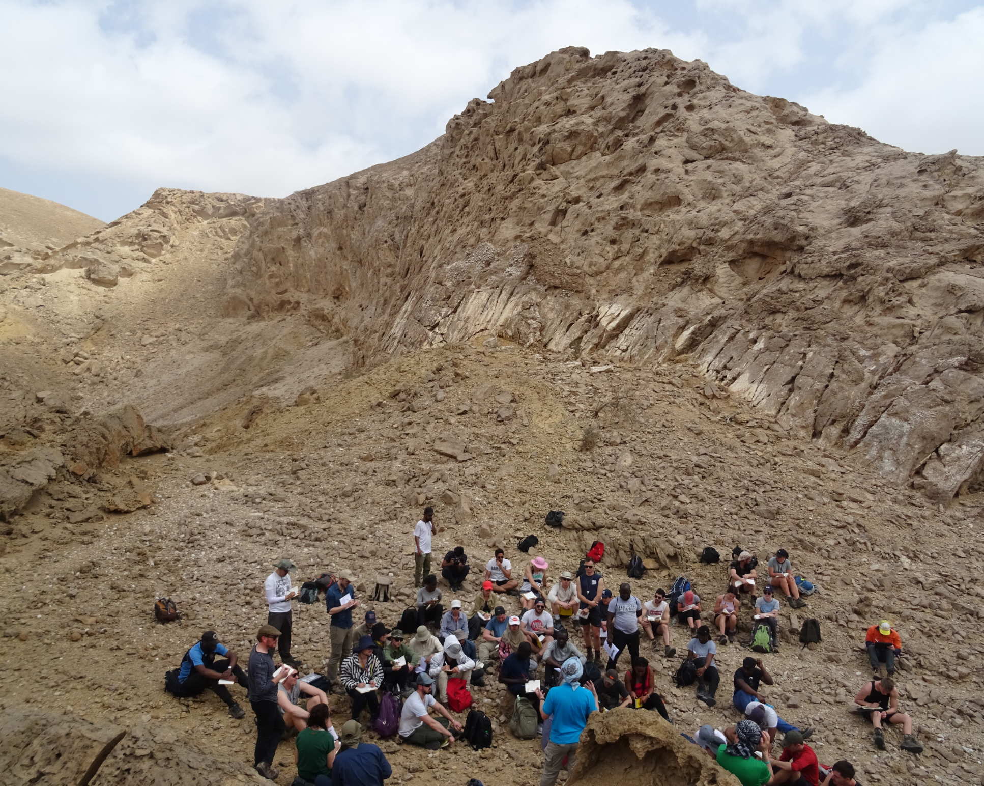 Petroleum Geoscience MSc students in Oman sitting on a large salt dome