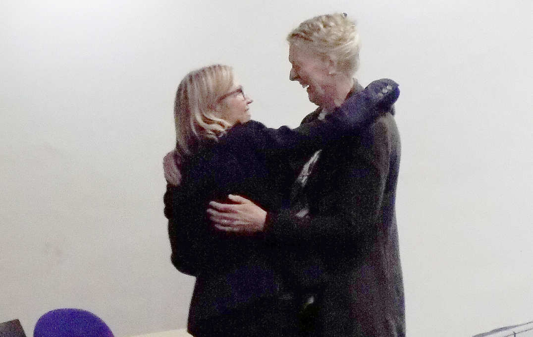 Jo and a colleague embrace at her retirement party
