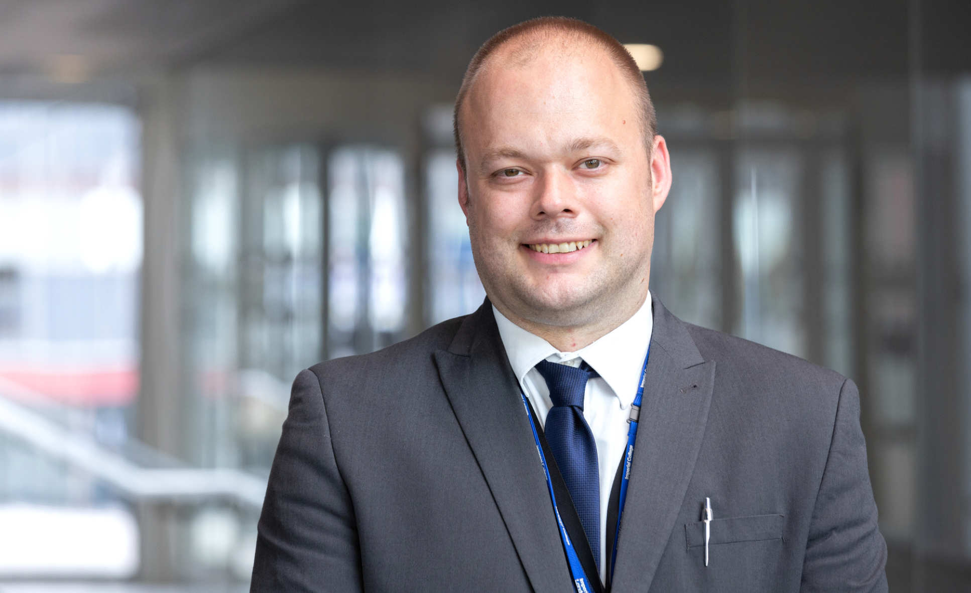 man in suit smiles at camera