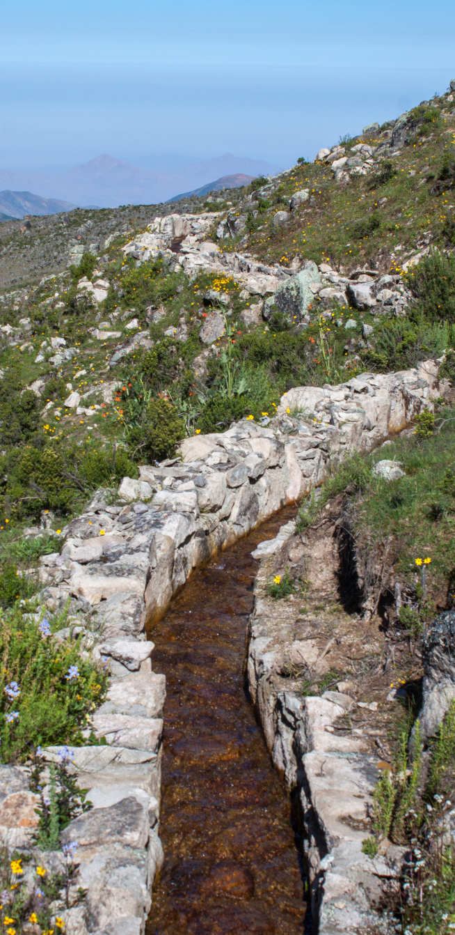 Photo of a dry diversion canal on an Andean mountainside