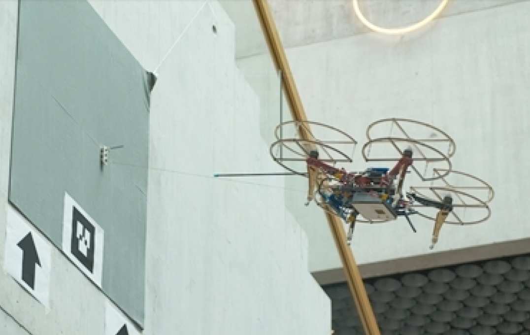 Photo of drone docking onto a wall
