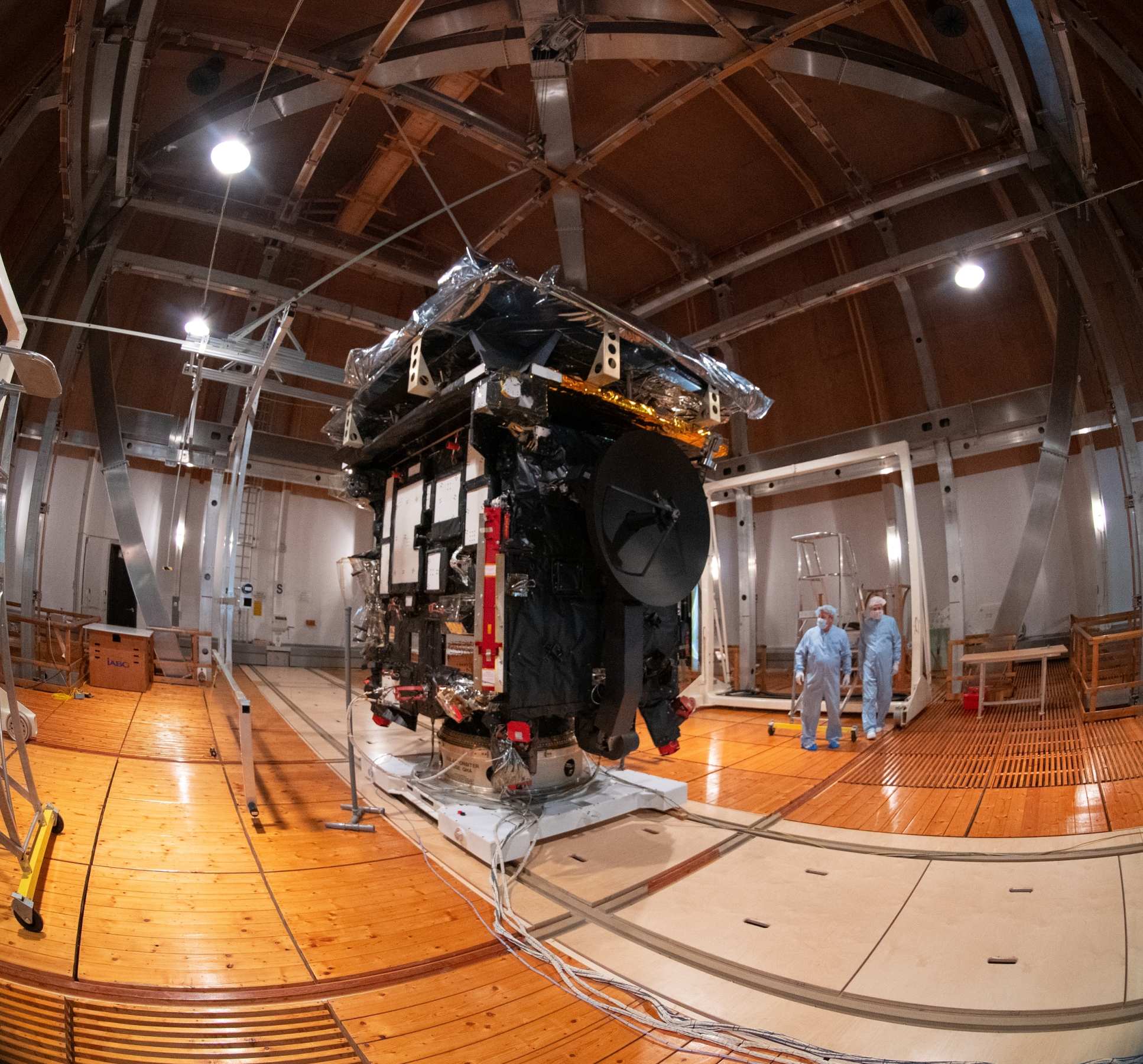 Worker in clean suits by the spacecraft