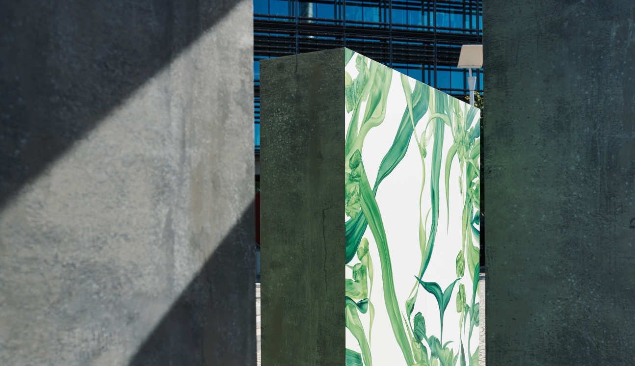 Artwork of green plants on concrete block