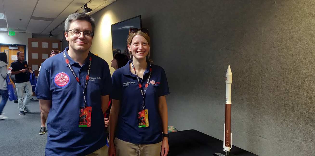 Proffor Tim Horbury and Helen O'Brien standing next to a model rocket