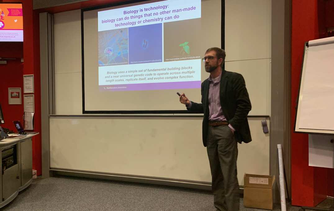 A man presenting in front of a screen