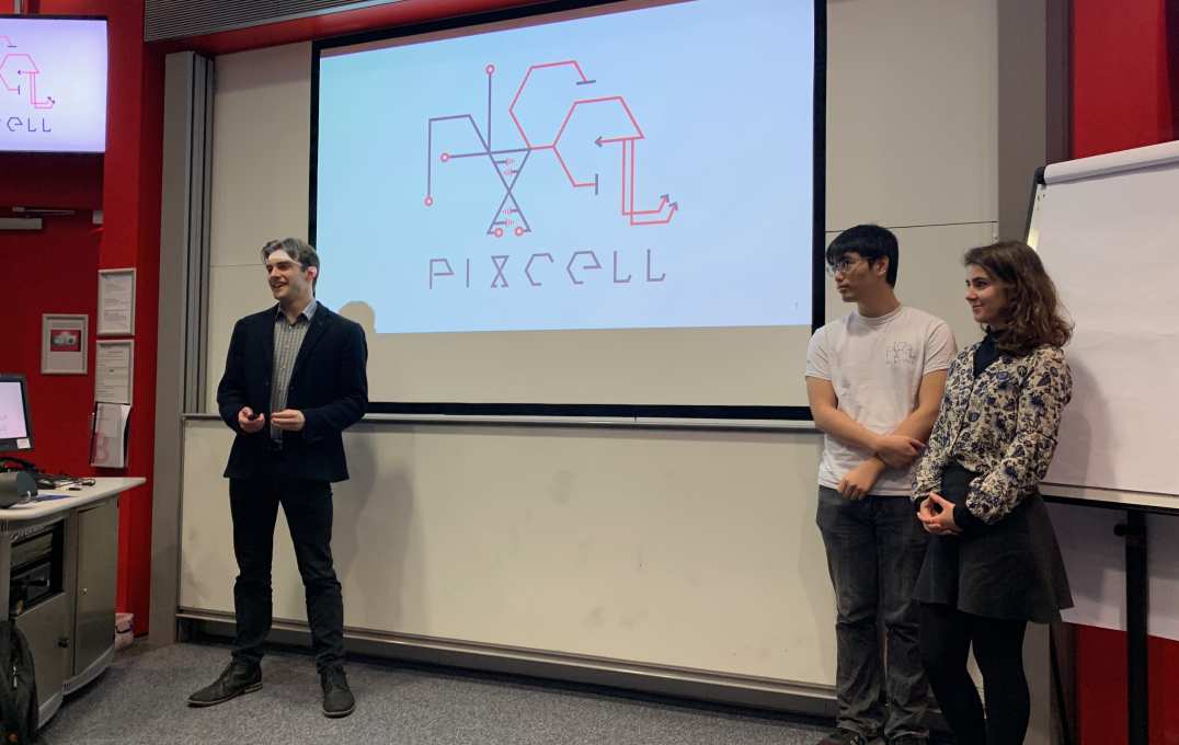 Three people in front of a screen that reads 'PixCell'