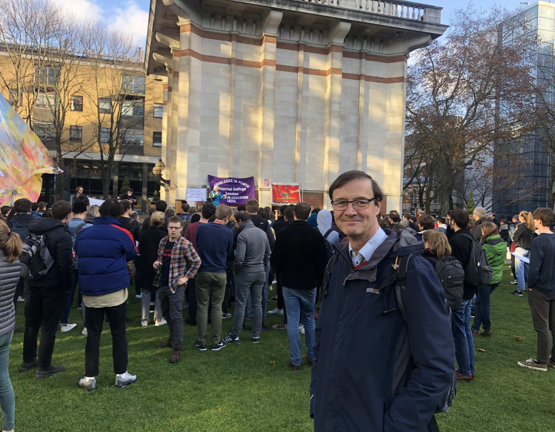 Paul Lickiss stands behind a climate protest on Imperial's Queens Lawn