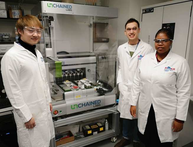 Simeng, Valerie and Roddy with one of ROAR’s high-throughput robotic reactors