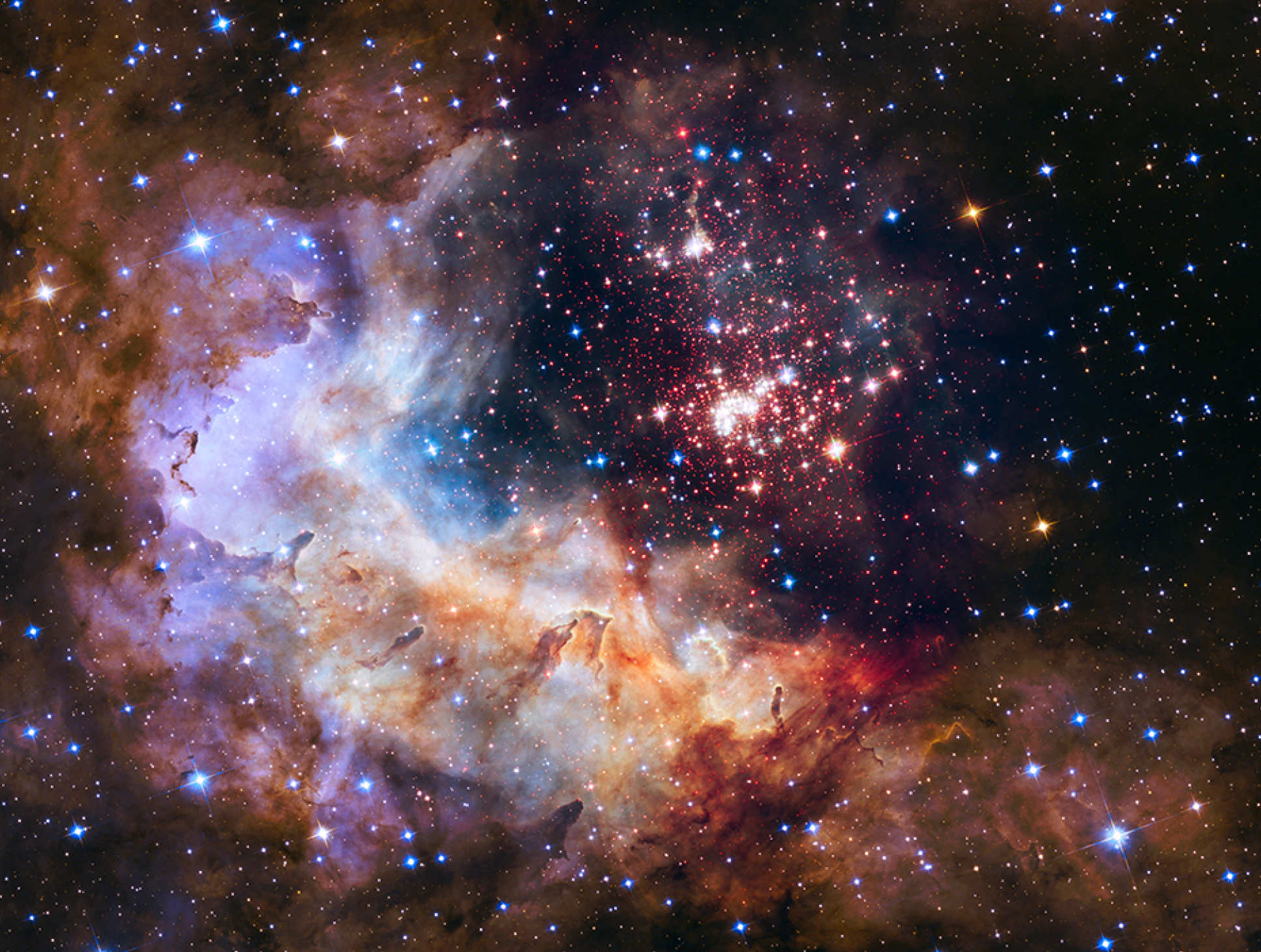 An image captured by the Hubble of Westerlund 2 - a giant a giant cluster of about 3,000 stars located 20,000 light-years away in the constellation Carina.