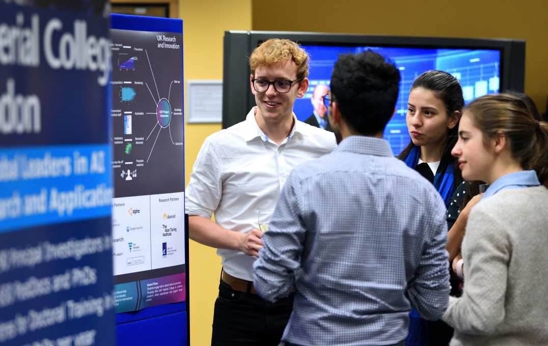 Guests discuss poster presentations after the lecture