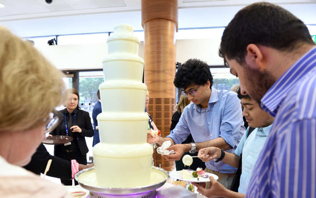 chocolate fountain with staff surrounding it
