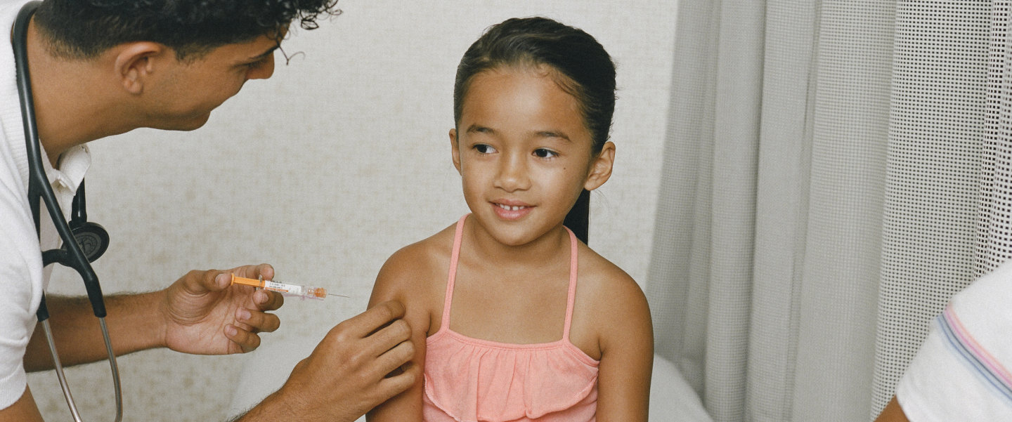 A young girl getting a vaccination