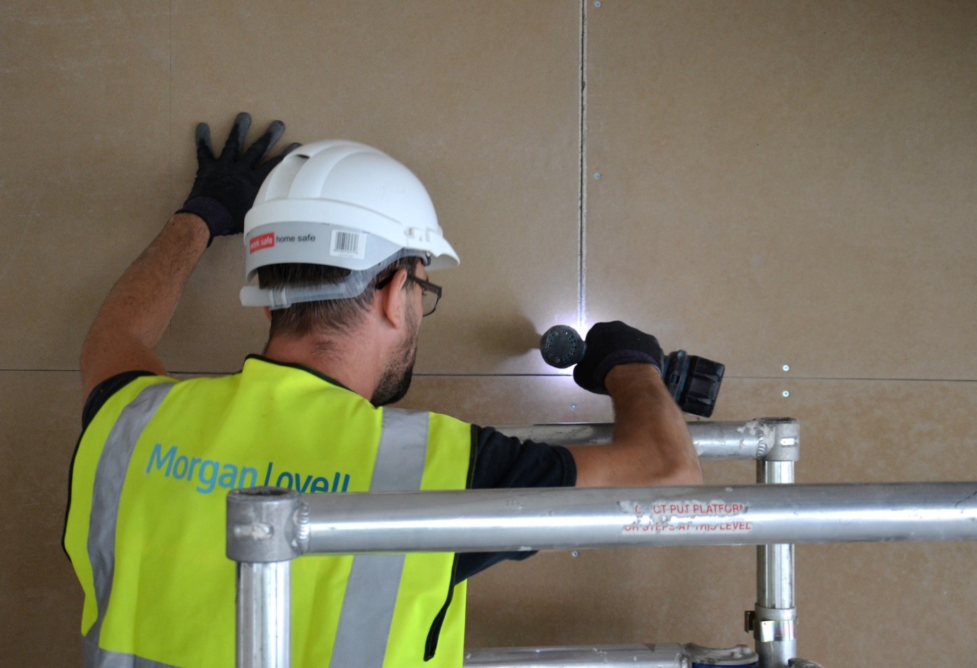 Builder installing Adaptavate's Breathaboard