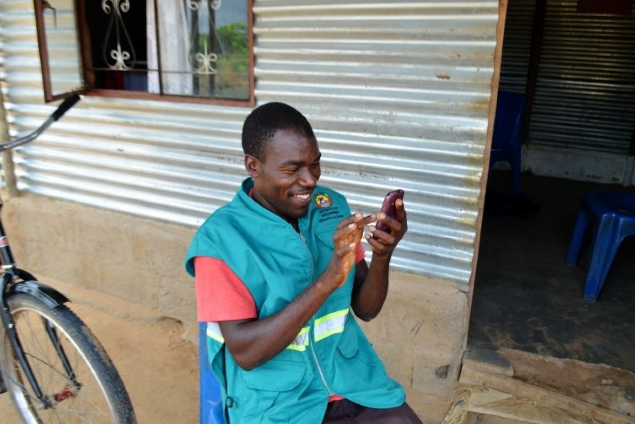 Man using a smartphone app to diagnose malaria