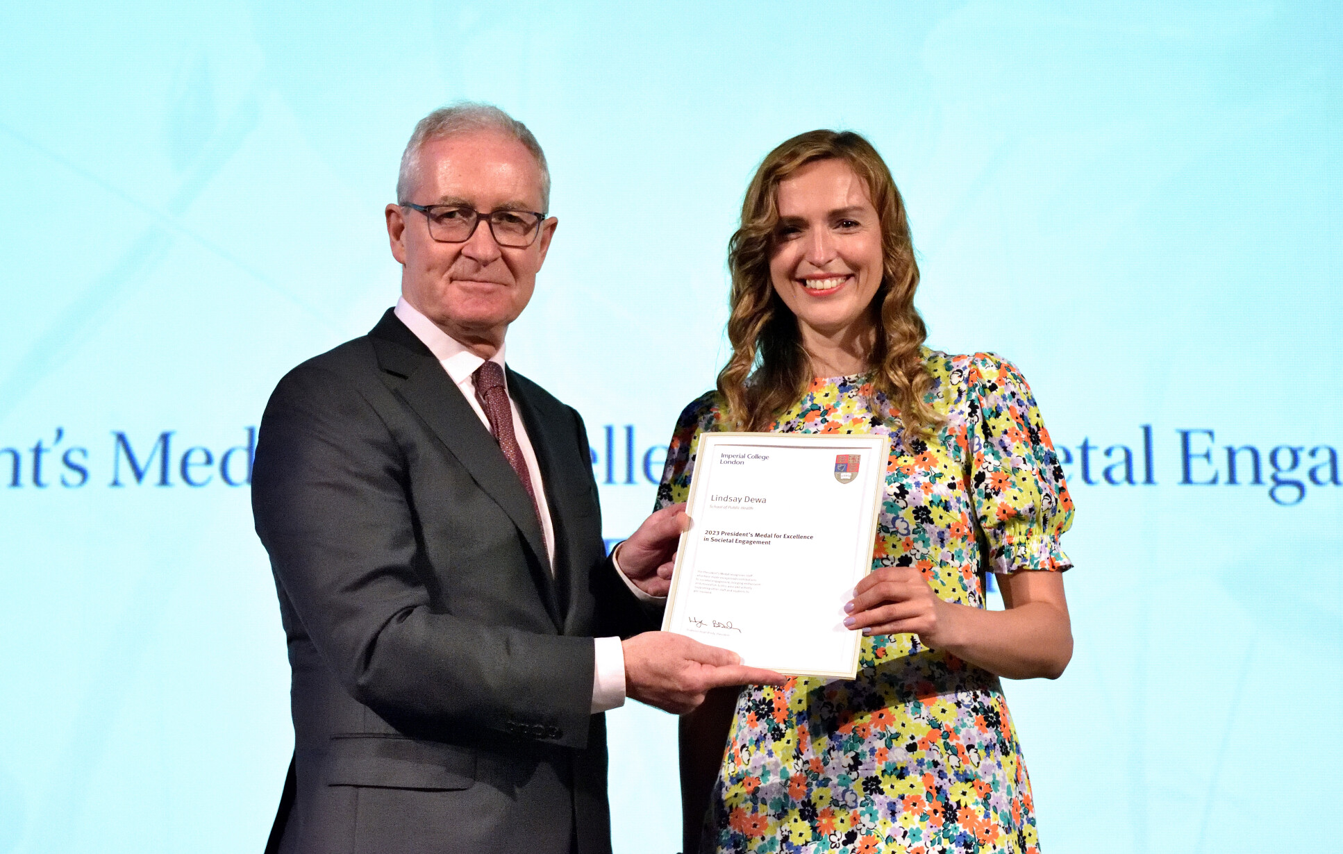 Dr Lindsay Dewa received an award from President Hugh Brady