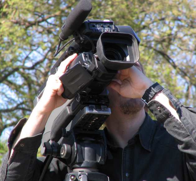 A man filming with a professional camera