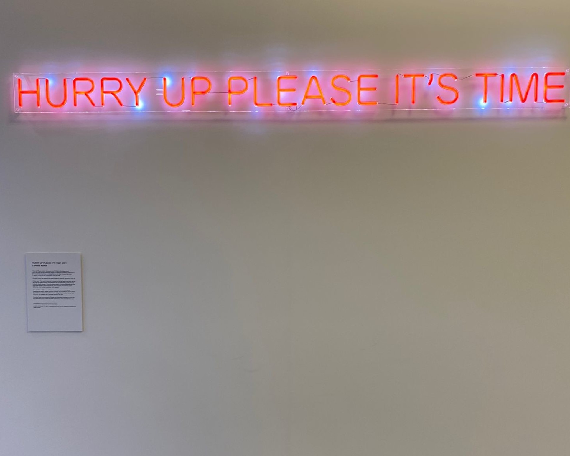 image of a white wall with glow writing 'Hurry up please it's time'