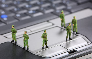 Tiny toy soldiers guarding a computer