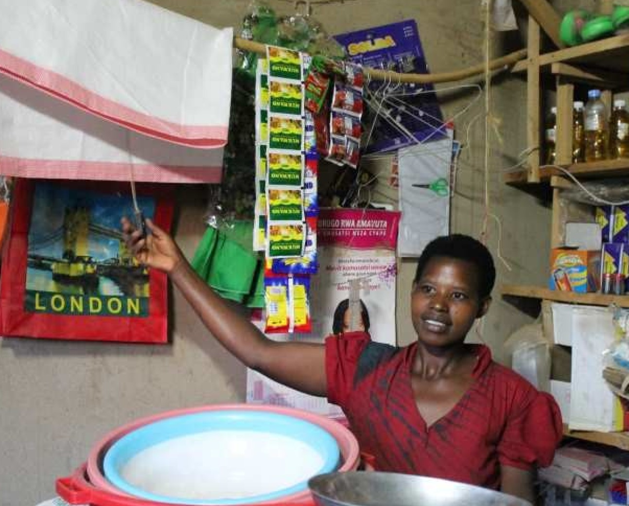 A woman in a shop in Rwanda clicking a power switch