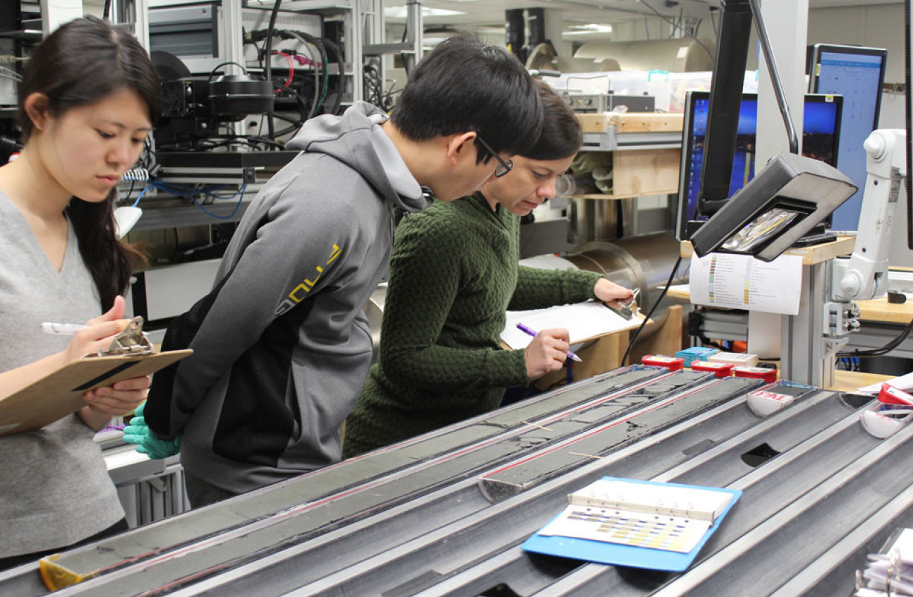 Researchers studying the sediment cores