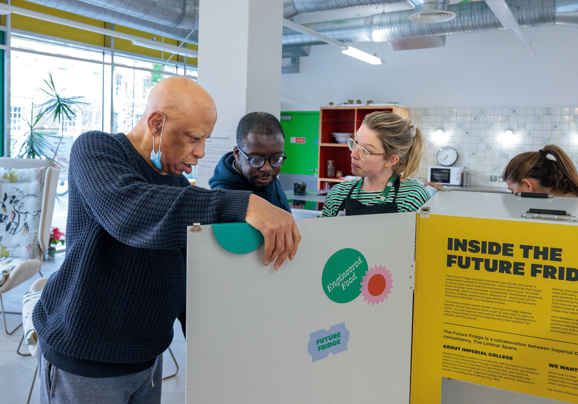 Visitors looking inside the Future Fridge at the pop-up at the Nourish Hub