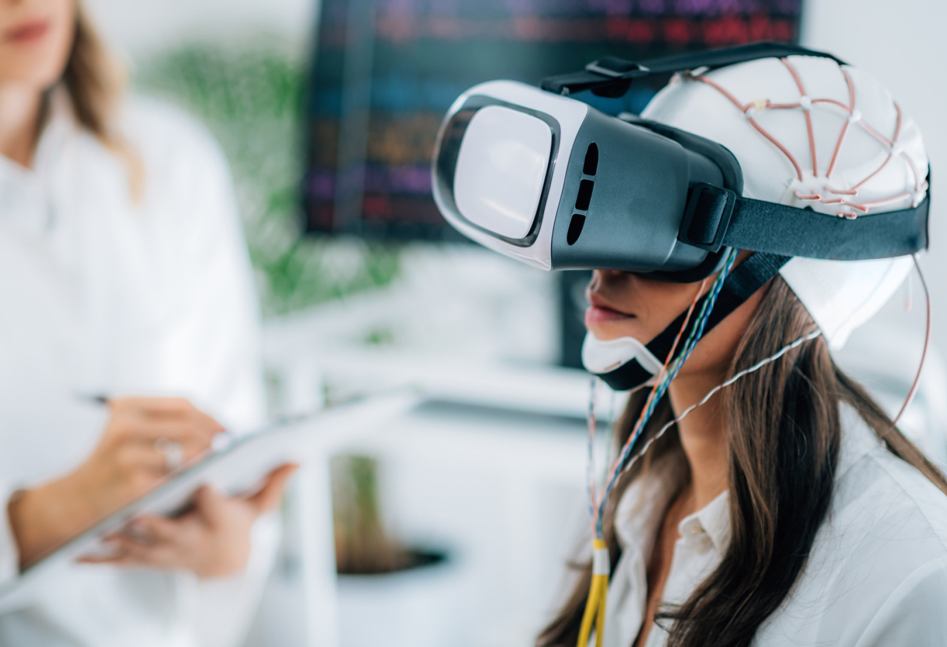 Patient in doctor's surgery wearing VR visor and EEG