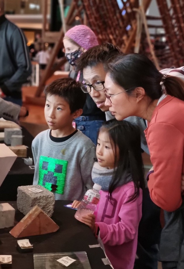 A family engaging with an exhibit at the Festival
