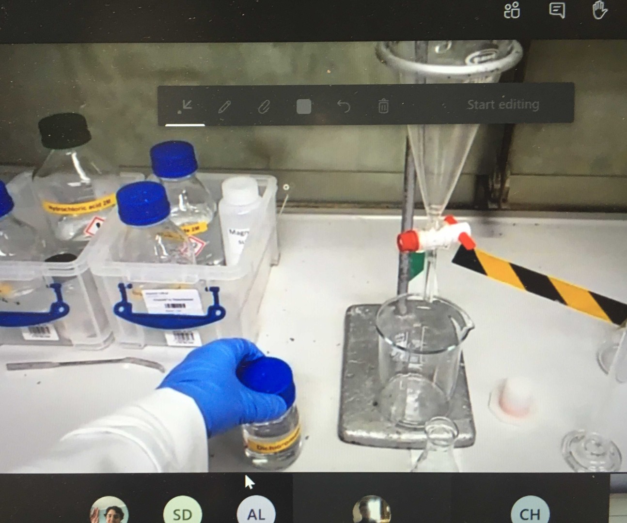 Laboratorytechnician's hand shown with chemistry equipment