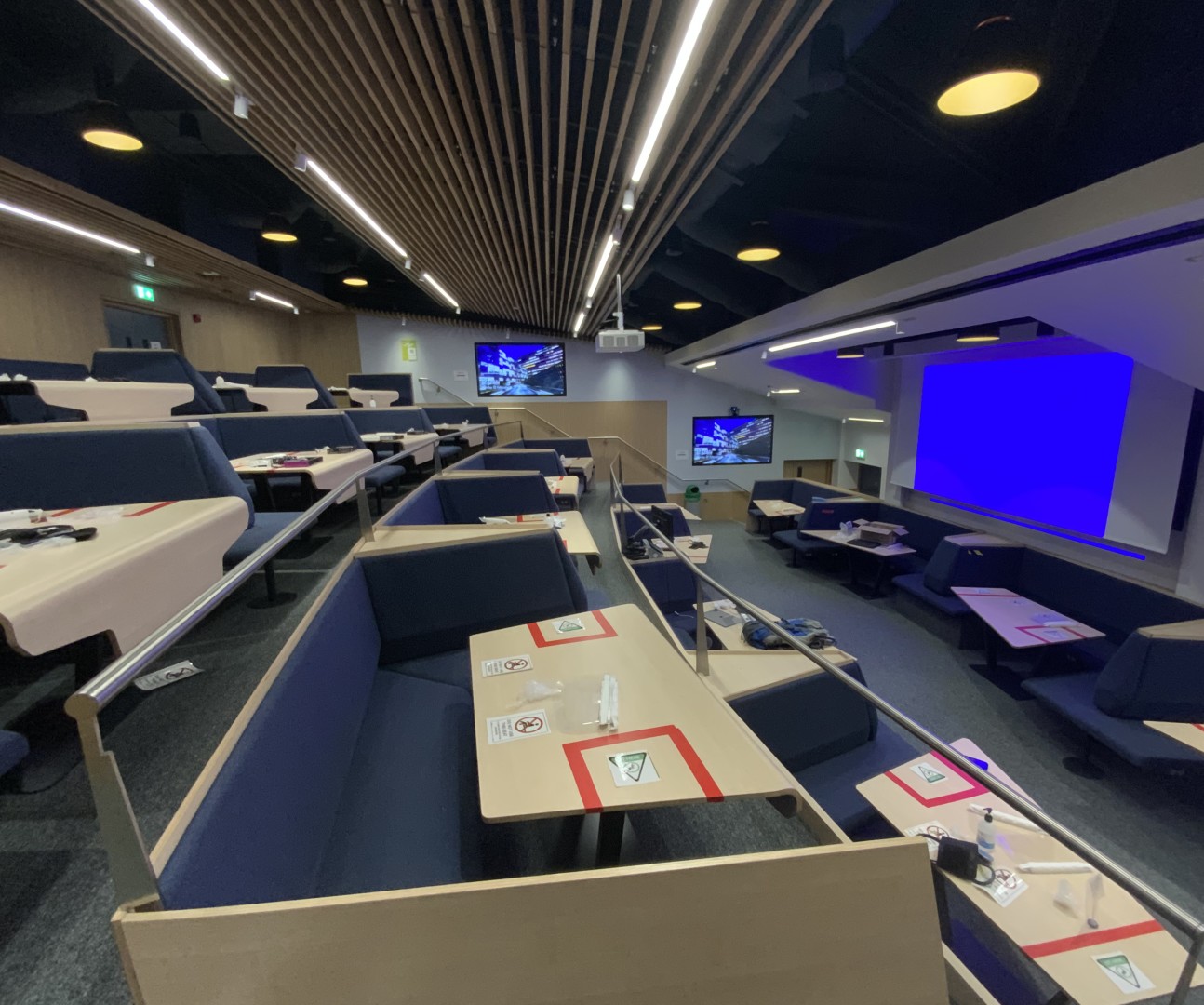 Image of Glenister Lecture Theatre with group teaching booths and multiple screens