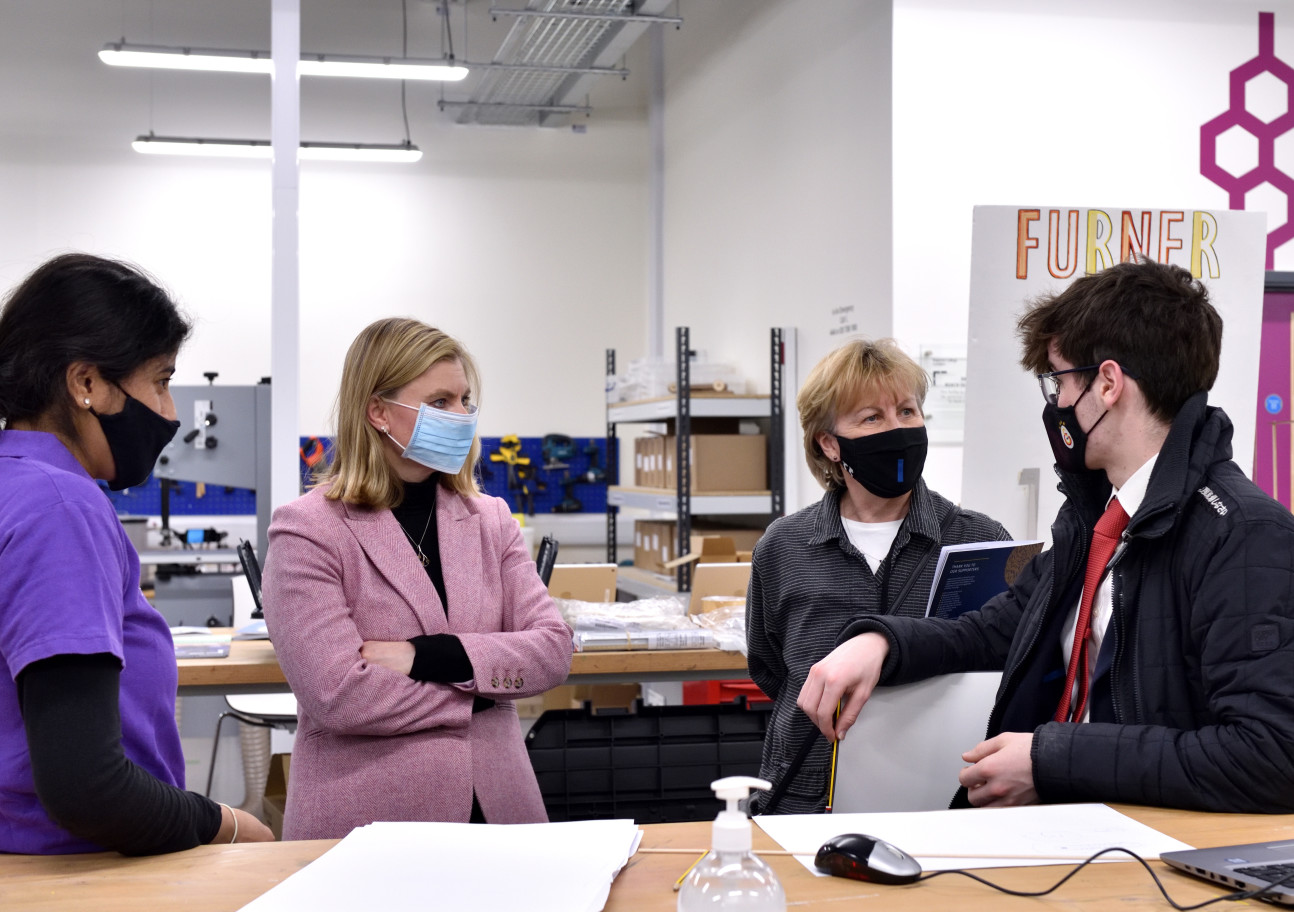 Justine Greening in the Makerspace hearing from Makerspace gradutes