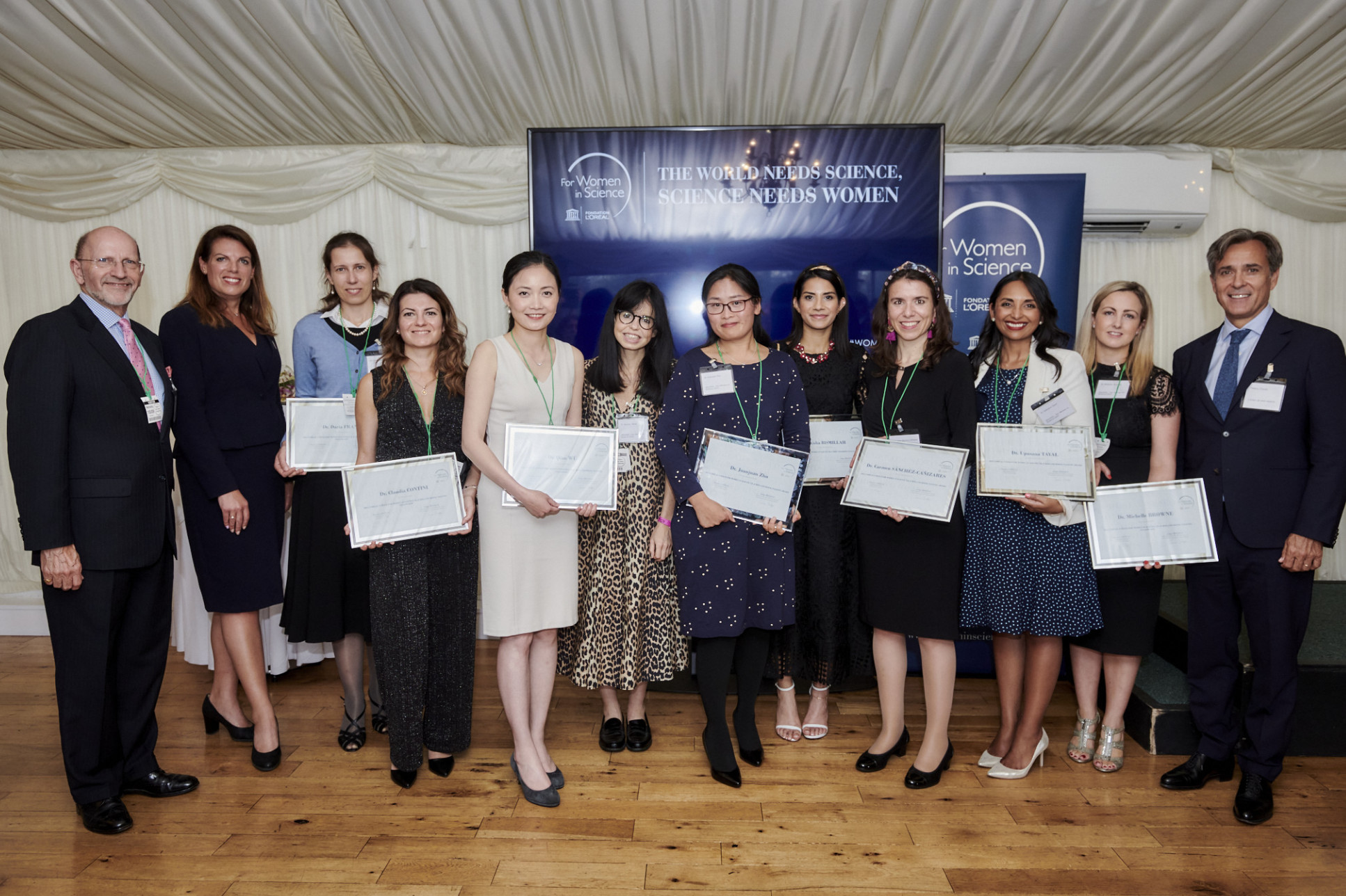 Line of people holding awards