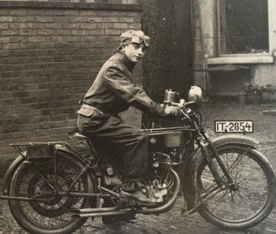 Black and white photo of Mac Goldsmith on motorbike in 1920